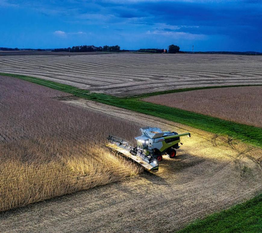 combine harvester on soybean field in evening