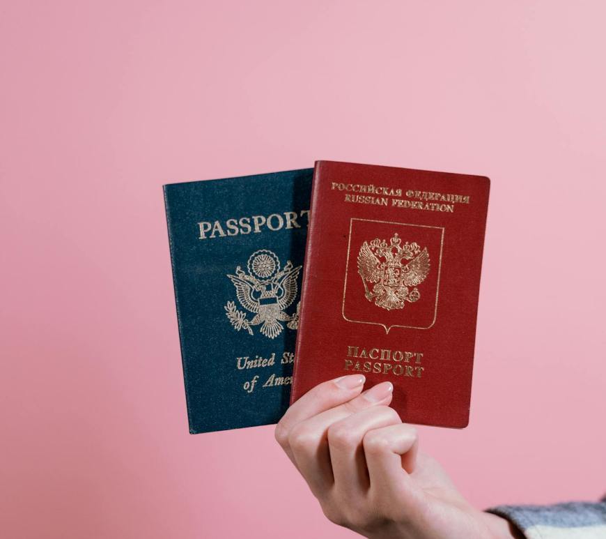 person holding red and blue book