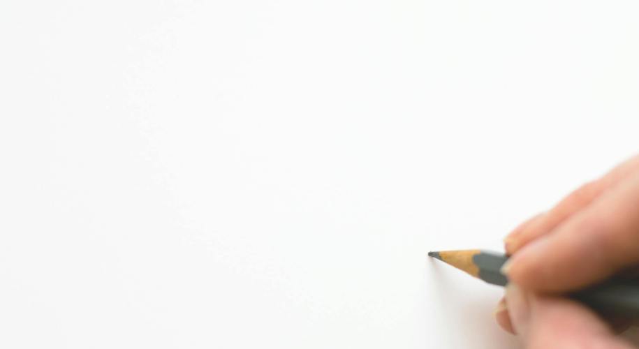 close up of hand holding pencil over white background